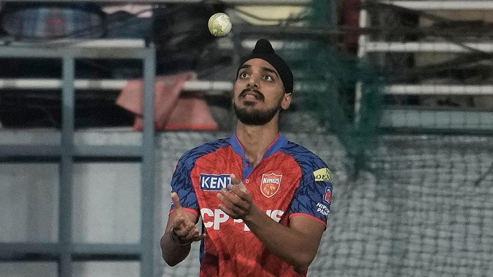 Punjab Kings' Arshdeep Singh tosses the ball after takes the catch to dismiss Gujarat Titans' Washington Sundar during the Indian Premier League cricket match between Gujarat Titans and Punjab Kings in New Chandigarh. - | Photo: AP/Ashwini Bhatia