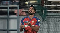 IPL 2026: Arshdeep Singh’s 'Racist' Remarks On Tilak Varma Spark Controversy, MI’ Post Fuels Debate | Photo: AP/Ashwini Bhatia : Punjab Kings' Arshdeep Singh tosses the ball after takes the catch to dismiss Gujarat Titans' Washington Sundar during the Indian Premier League cricket match between Gujarat Titans and Punjab Kings in New Chandigarh.