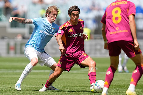 Roma's Paulo Dybala, right, and Lazio's Nicolo Rovella challenge for the ball during the Italian Serie A soccer match between Roma and Lazio in Rome.
