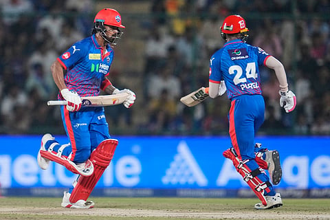 Delhi Capitals' KL Rahul, left and his batting partner Abhishek Porel run between the wickets during the Indian Premier League cricket match between Delhi Capitals and Rajasthan Royals in New Delhi, India.
