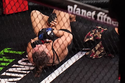 Ronda Rousey, of the United States, left, fights Gina Carano, of the United States, during their featherweight mixed martial arts fight in Inglewood, Calif.
