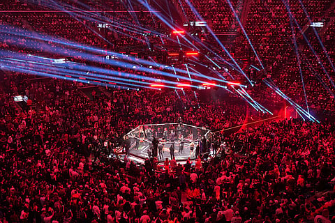 Fans look on as Gina Carano, of the United States, and Ronda Rousey, of the United States, are introduced before their featherweight mixed martial arts fight in Inglewood, Calif.