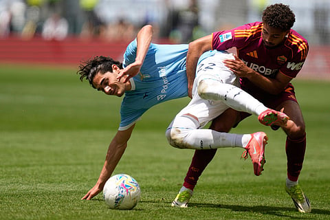 Roma's Devyne Rensch, right, and Lazio's Matteo Cancellieri challenge for the ball during the Italian Serie A soccer match between Roma and Lazio in Rome.