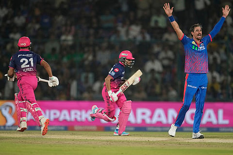 Delhi Capitals' Mitchel Starc, right, appeals successfully for the wicket of Rajasthan Rajasthan Royals' Ravi Singh, center, during the Indian Premier League cricket match between Delhi Capitals and Rajasthan Royals in New Delhi, India.