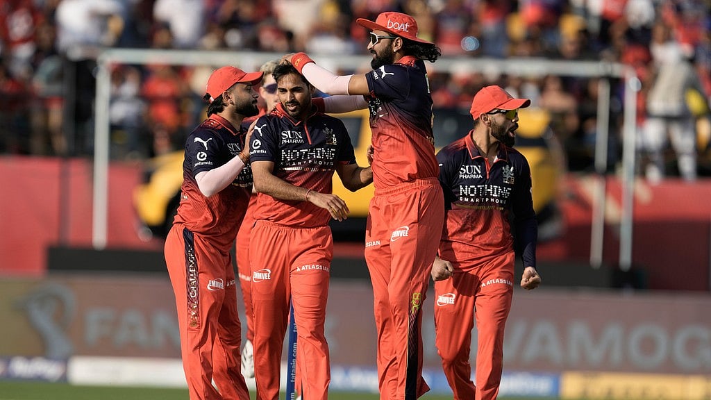 Royal Challengers Bengaluru's Bhuvneshwar Kumar, second left, celebrates with teammates the wicket of Punjab Kings' Priyansh Arya during the Indian Premier League cricket match between Punjab Kings and Royal Challengers Bengaluru in Dharamshala, India, Sunday, May 17, 2026. - AP Photo/Ashwini Bhatia
