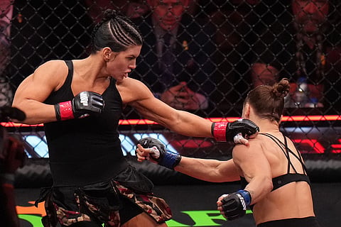 Gina Carano, of the United States, left, fights Ronda Rousey, of the United States, during their featherweight mixed martial arts fight in Inglewood, Calif. 