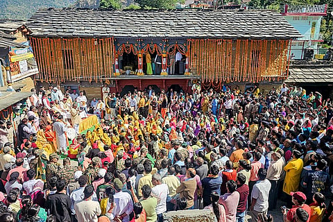 People gather as the ceremonial palanquin procession of Lord Rudranath leaves for the temple from its winter abode at the 'Gopinath Temple', in Gopeshwar, Chamoli district, Uttarakhand.
