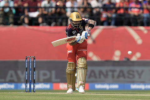 Royal Challengers Bengaluru's Virat Kohli plays a shot during the Indian Premier League cricket match between Punjab Kings and Royal Challengers Bengaluru in Dharamshala, India.