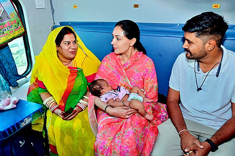 In this image posted on May 17, 2026, Rajasthan Deputy Chief Minister Diya Kumari, centre, travels by train and interacts with passengers during her journey to Ajmer, Rajasthan.