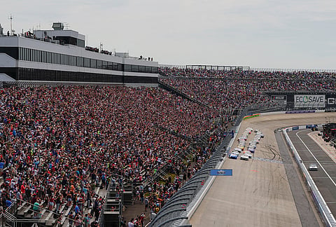 Denny Hamlin (11) and Brad Keselowski (6) lead the field to the green flag to start the NASCAR All-Star auto race at Dover Motor Speedway, in Dover, Delaware. 