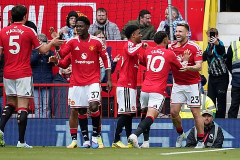 Manchester United's Luke Shaw, right, celebrates with teammates after scoring his side's opening goal during the English Premier League soccer match between Manchester United and Nottingham Forest in Manchester, England.