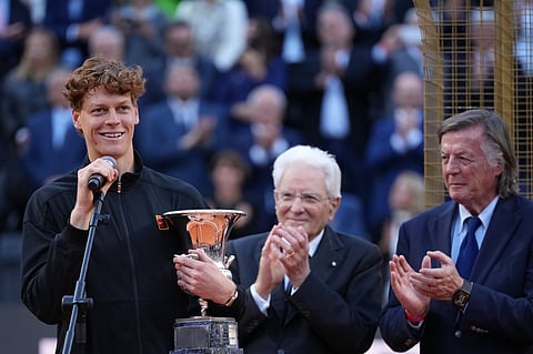 Jannik Sinner, of Italy, holds his trophy while Italian President Sergio Mattarella, center, and former tennis champion Adriano Panatta applaud, after defeating Casper Ruud, of Norway, in the final match to win the Italian Open tennis tournament, in Rome, Sunday.