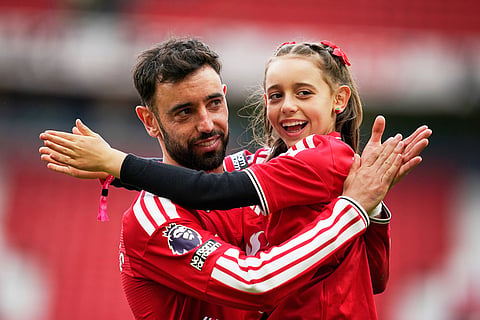 Manchester United's Bruno Fernandes plays with his kid after the English Premier League soccer match between Manchester United and Nottingham Forest in Manchester, England.