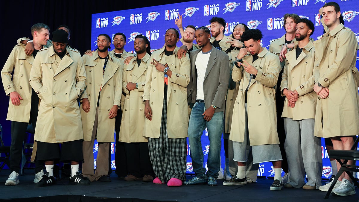 Oklahoma City Thunder guard Shai Gilgeous-Alexander, center, poses with teammates in Burberry trench coats he bought during a news conference. - AP/Nate Billings