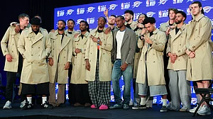 AP/Nate Billings : Oklahoma City Thunder guard Shai Gilgeous-Alexander, center, poses with teammates in Burberry trench coats he bought during a news conference.