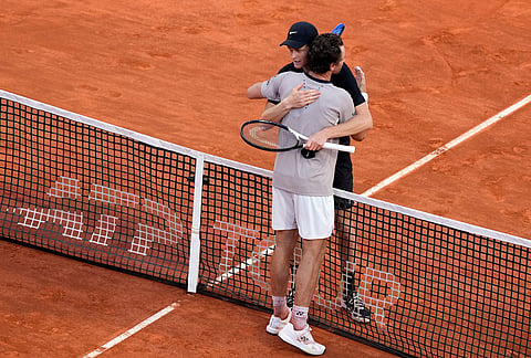 Jannik Sinner, of Italy, embraces Casper Ruud, of Norway, after defeating him 6/4, 6/4 in the final match at the Italian Open tennis tournament, in Rome.