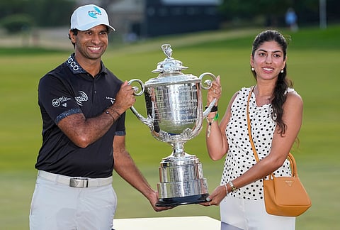 Aaron Rai, of England, and wife Gaurika Bishnoi hold the Wanamaker Trophy after winning the PGA Championship golf tournament at Aronimink Golf Club, in Newtown Square, Pennsylvania.