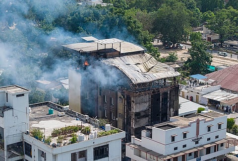 Smoke billows after a blaze broke out at a hotel in the Civil Lines area, in Prayagraj.