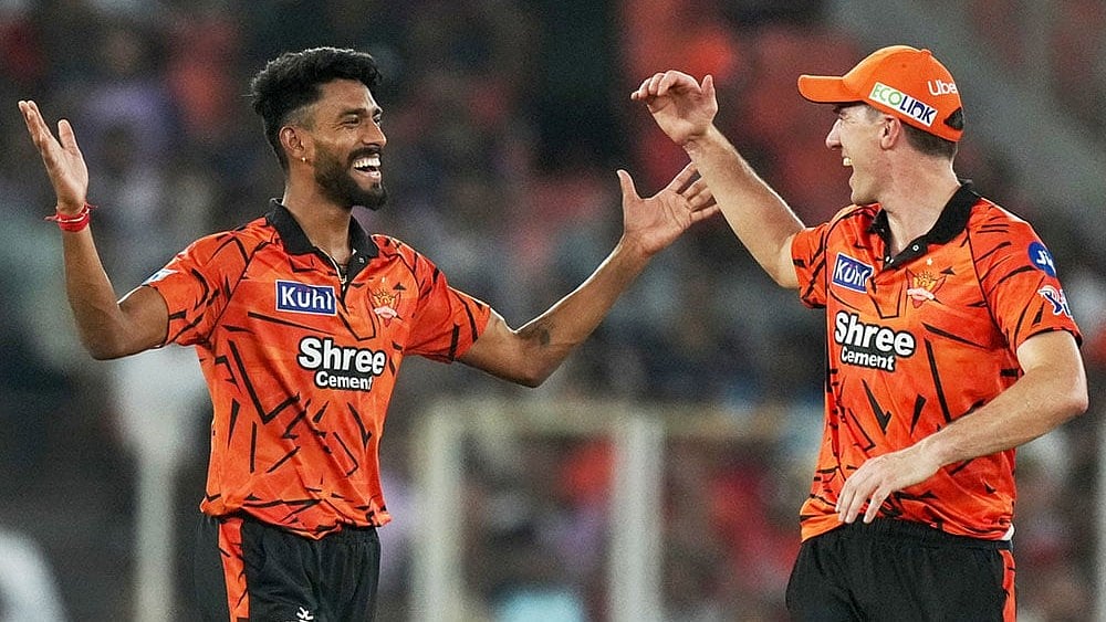 Sunrisers Hyderabad's Praful Hinge, left and Pat Cummins celebrates the wicket of Gujarat Titans' Jos Buttler during the Indian Premier League cricket match between Gujarat Titans and Sunrisers Hyderabad, in Ahmedabad, India. - | Photo: AP/Ajit Solanki