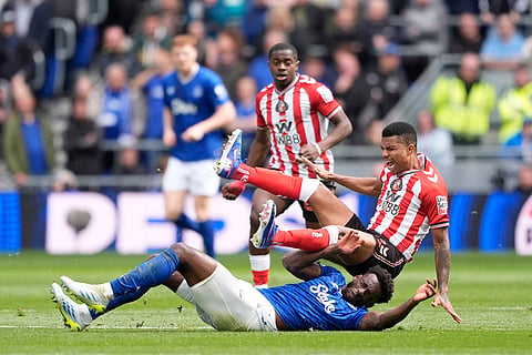 Everton's Tim Iroegbunam, below, fouls Sunderland's Reinildo Mandava during their English Premier League soccer match in Liverpool, England.