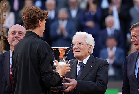 Jannik Sinner, of Italy, receives his trophy from Italian President Sergio Mattarella after defeating Casper Ruud, of Norway, 6/4, 6/4 in the final match to win the Italian Open tennis tournament, in Rome.