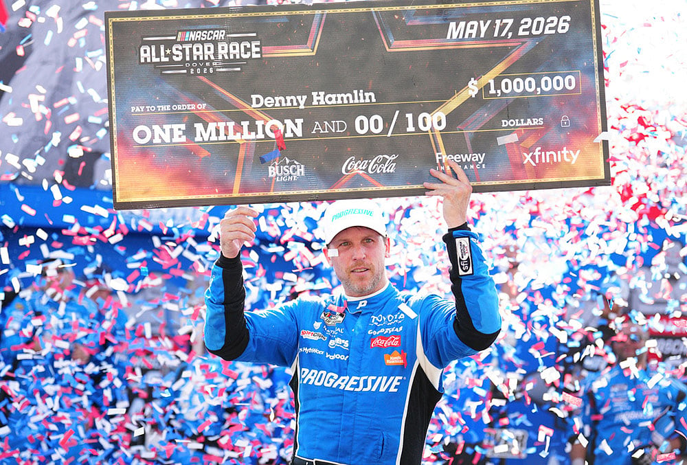 Denny Hamlin celebrates in Victory Lane after winning the NASCAR All-Star auto race at Dover Motor Speedway in Dover, Delaware. - | Photo: AP/Derik Hamilton