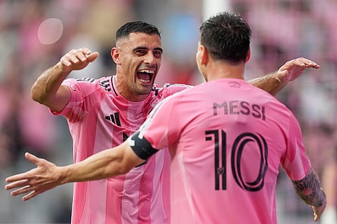Inter Miami forward German Berterame runs to hug midfielder Leo Messi (10) after scoring against the Portland Timbers during the first half of an MLS soccer match in Miami.