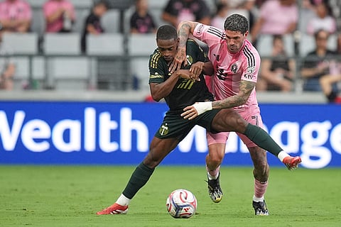 Portland Timbers midfielder David da Costa, left, comes under pressure from Inter Miami midfielder Rodrigo de Paul during the second half of an MLS soccer match in Miami.