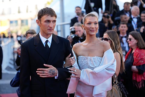 Anwar Hadid, left, and Bella Hadid pose for photographers upon arrival at the premiere of the film 'Garance' at the 79th international film festival, Cannes, southern France.