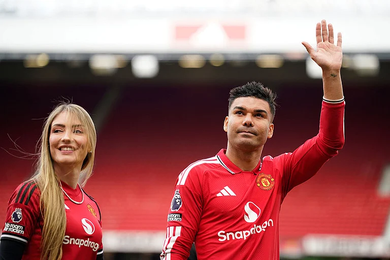 Manchester United's Casemiro leaves the pitch with his wife Anna Mariana after his last game for the club at the end of English Premier League soccer match between Manchester United and Nottingham Forest in Manchester, England. - | Photo: AP/Dave Thompson