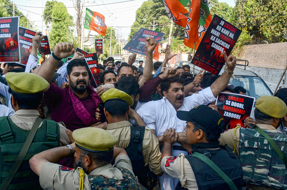 BJP Kashmir unit members in a scuffle with the police personnel after they took out a protest rally towards the residence of Jammu and Kashmir Chief Minister, against the operation of wine shops in the Kashmir Valley, demanding a complete ban on liquor sales, in Srinagar. - PTI