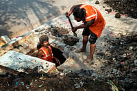 SURESH K PANDEY : Labourers clean a drainage line before the beginning of monsoon in Okhla, New Delhi.