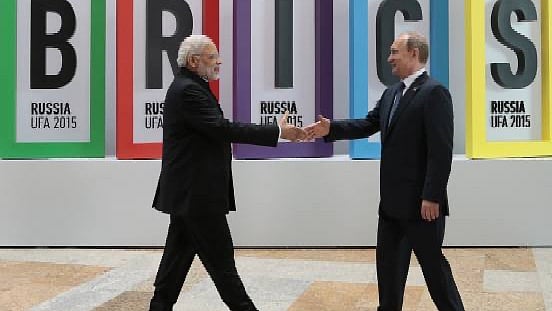 PM Modi greets Russian President Vladimir Putin during an earlier BRICS summit - null