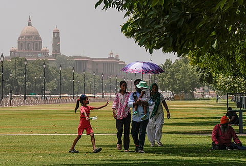 People cover themselves on a hot summer day, in New Delhi. Delhi experienced a warm Tuesday morning as the minimum temperature settled at 28.2 degrees Celsius while the India Meteorological Department (IMD) issued a 'yellow' alert for heatwave conditions, with isolated places in the city likely to reel under intense heat during the day. 