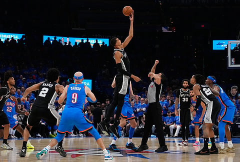 San Antonio Spurs forward Victor Wembanyama (1) tips off during overtime of Game 1 in a third-round NBA basketball playoffs series against the Oklahoma City Thunder in Oklahoma City. 