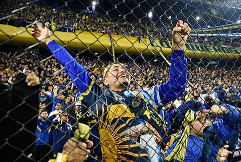 A fan of Argentina's Boca Juniors cheers prior to a Copa Libertadores Group D soccer match against Brazil's Cruzeiro in Buenos Aires, Argentina.