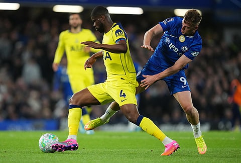 Tottenham's Kevin Danso, left, and Chelsea's Liam Delap fight for the ball during a Premier League soccer match between Chelsea and Tottenham in London.