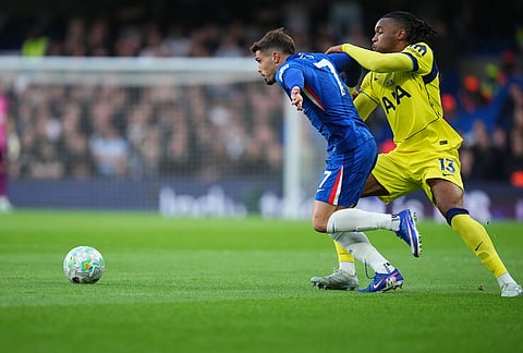 Tottenham's Destiny Udogie, right, and Chelsea's Pedro Neto fight for the ball during a Premier League soccer match between Chelsea and Tottenham in London.
