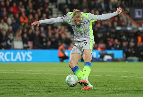 Manchester City's Erling Haaland scores his side's opening goal during the English Premier League soccer match between AFC Bournemouth and Manchester City in Bournemouth, England.