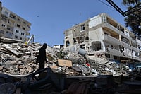 Mustafa Jamalddine, AP : A man walks next to buildings destroyed in Israeli airstrikes in the southern village of Maarakeh, Lebanon, May 17, 2026. 