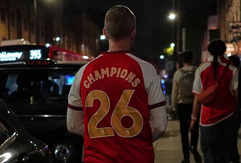An Arsenal supporter leaves the Arsenal fan celebration after Arsenal's soccer team won the Premier League title in London.