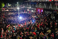 | Photo: AP/Alberto Pezzali : Arsenal supporters gather to celebrate at the Arsenal stadium after Arsenal's soccer team won the Premier League title in London.