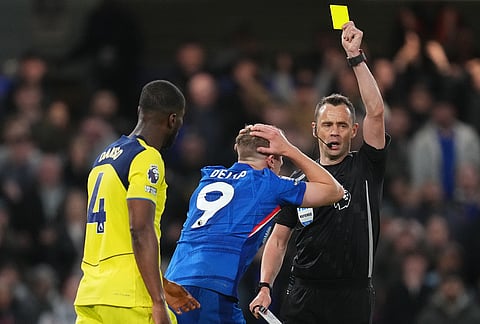 Chelsea's Liam Delap receives the yellow card during a Premier League soccer match between Chelsea and Tottenham in London.