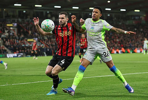 Manchester City's Savinho, right, challenges for the ball with Bournemouth's Lewis Cook during the English Premier League soccer match between AFC Bournemouth and Manchester City in Bournemouth, England.