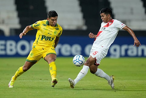 Igor Carius of Brazil's Mirassol, left, and Dieguito Rodriguez of Bolivia's Always Ready battle for the ball during a Copa Libertadores Group G soccer match in Asuncion, Paraguay.