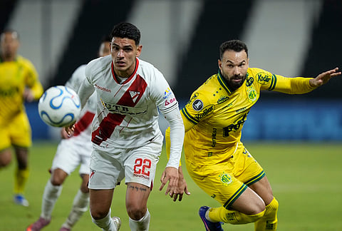 Edson Carioca of Brazil's Mirassol, right, and Richet Gomez of Bolivia's Always Ready battle for the ball during a Copa Libertadores Group G soccer match in Asuncion, Paraguay.