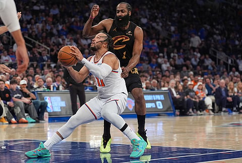New York Knicks' Jalen Brunson, bottom, drives past Cleveland Cavaliers' James Harden during the second half of Game 1 in the Eastern Conference finals NBA basketball playoffs series in New York. 