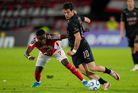 Jhojan Torres of Colombia's Independiente Santa Fe, left, and Franco Zapiola of Argentina's Platense battle for the ball during a Copa Libertadores Group E soccer match in Bogota, Colombia.