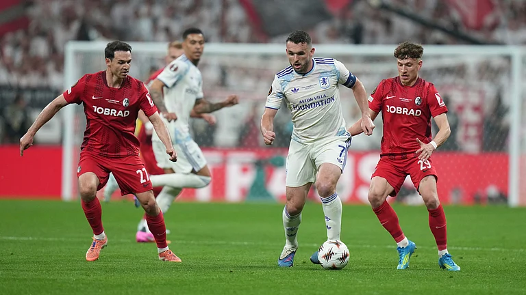 Freiburg's Phillip Treu, right, and Nicolas Hofler, left, defend against Aston Villa's John McGinn during the Europa League final soccer match between Freiburg and Aston Villa in Istanbul, Turkey. - AP Photo