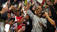Did Botswana Government Really Give Arsenal Fans A Day Off To Celebrate Title Win? Viral Claim Fact-Checked | Photo: AP/Alberto Pezzali : Former Arsenal player Ian Wright celebrates with Arsenal supporters at the Arsenal stadium after Arsenal's soccer team won the Premier League title in London, Tuesday, May 19, 2026.